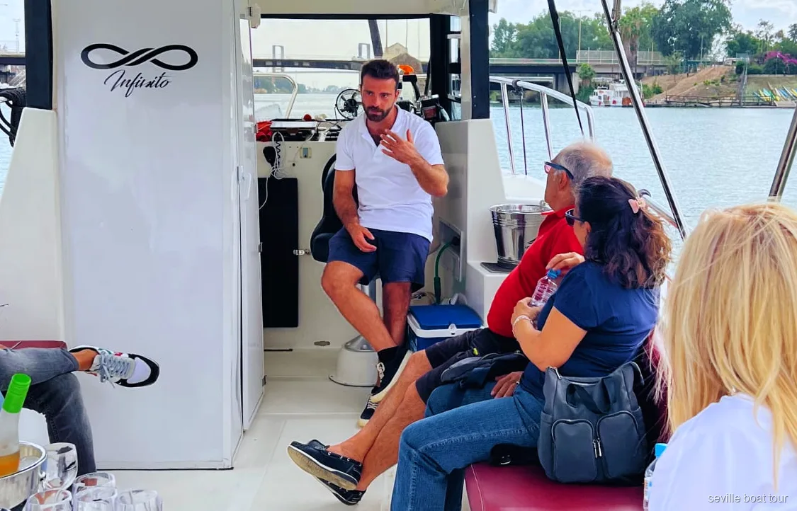 Guided Guadalquivir Boat Tour with captain narrating past Torre del Oro