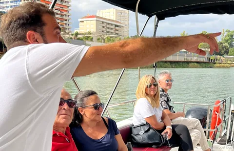 Small group on the Guided Guadalquivir Boat Tour enjoying a drink on board