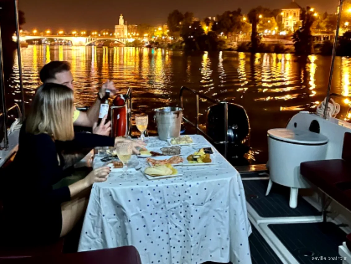 Private boat departing near Puente de San Telmo for the Seville Romantic Boat Ride